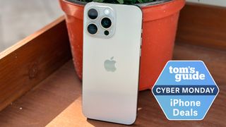An iPhone 15 Pro Max with a Tom's Guide Cyber Monday iPhone deals badge