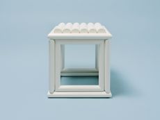 White square stool featuring lacquered wood and scalloped leather seat by Jonathan Saunders