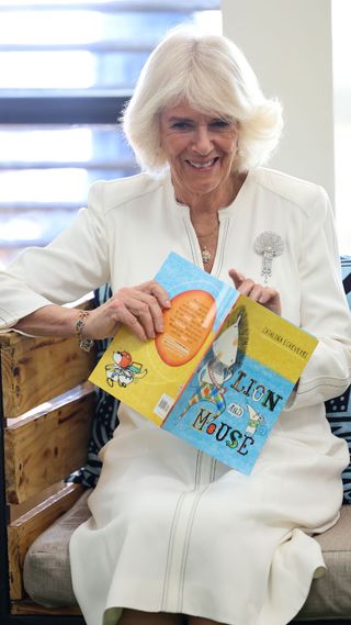 Camilla reading a children's book at a library in Nairobi.