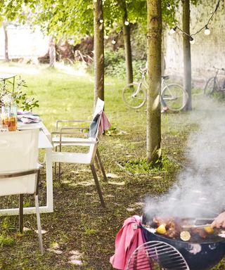 An example of barbecue recipes showing a smoky barbecue next to trees and a white dining table