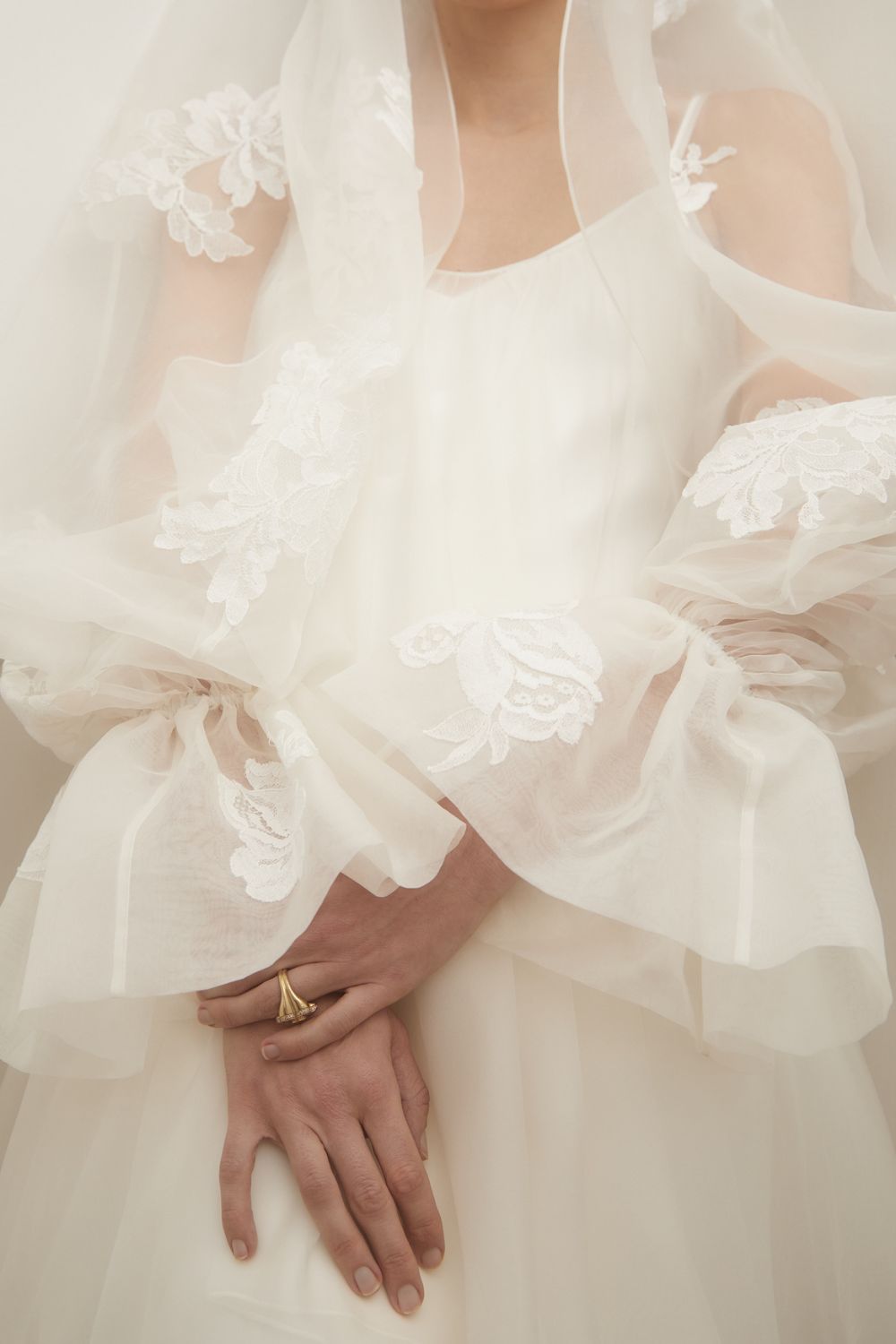 a close-up of a model wearing a wedding dress