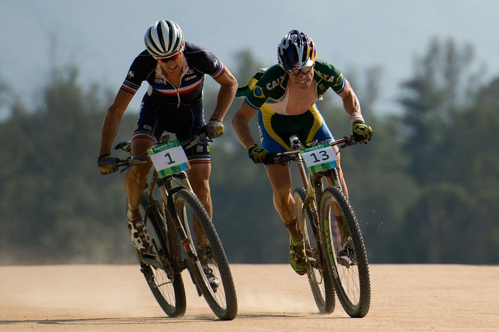 Julien Absalon of France sprints ahead of Henrique Avancini of Brazil