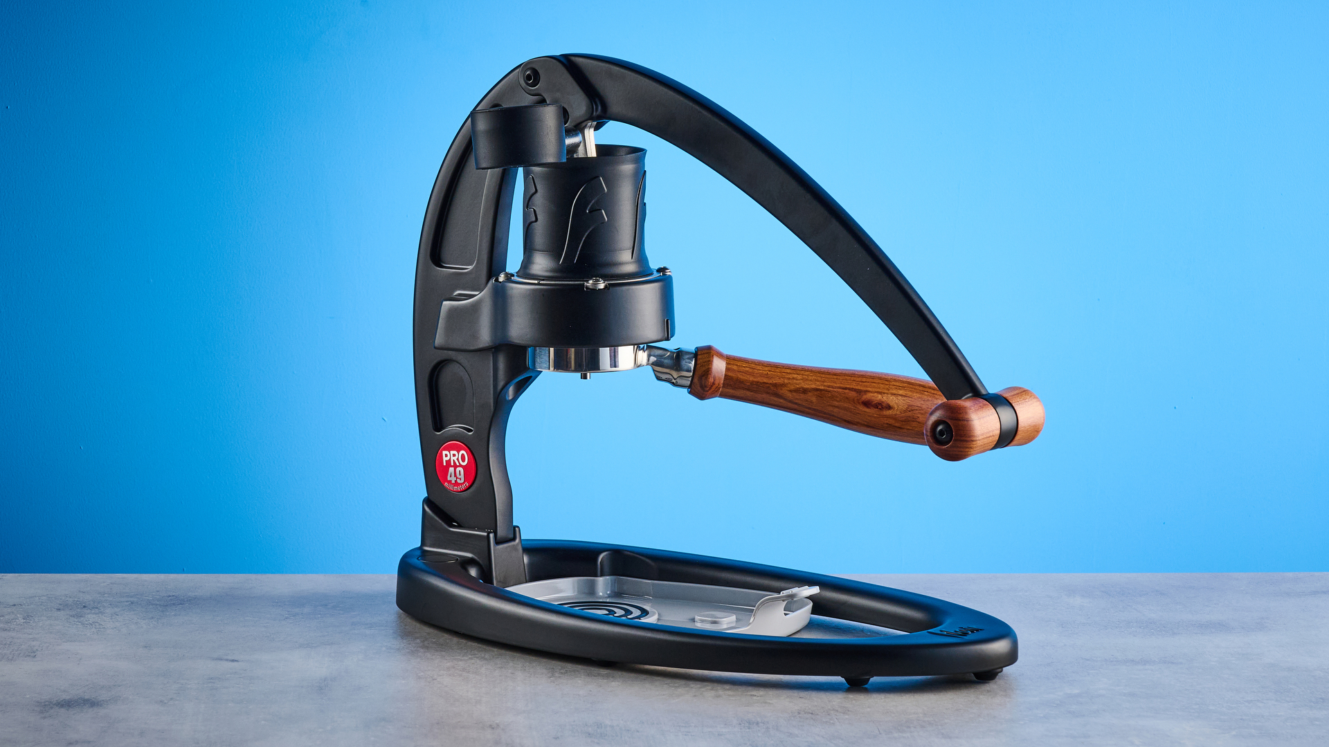 the flair 49 pro lever espresso machine photographed against the blue tom's guide background