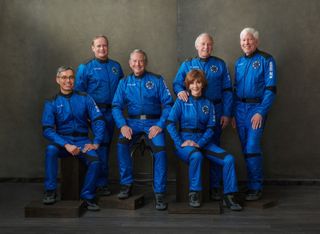 a group of people in blue flight suits