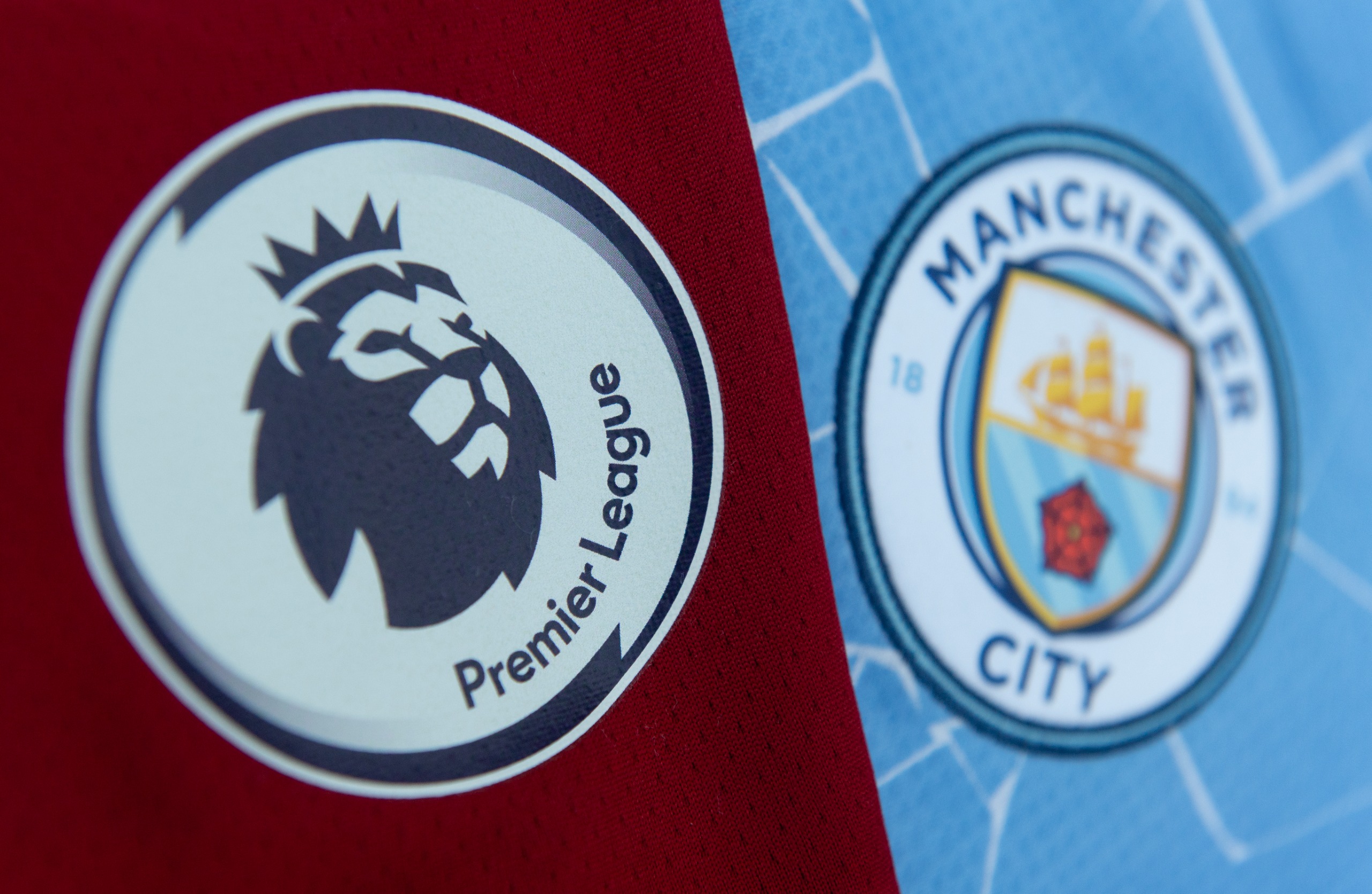 Manchester City and the Premier League badges side by side