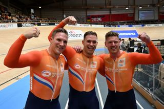 Netherlands' Roy Van Den Berg (R), Netherlands' Harrie Lavreysen (C) and Netherlands' Jeffrey Hoogland celebrate after winning the men's team sprint final race of the UCI Track Cycling World Championships in Ballerup, Denmark, on October 16, 2024. (Photo by Jonathan NACKSTRAND / AFP)