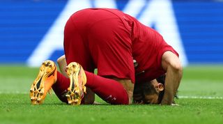 Liverpool forward Mohamed Salah kisses the Anfield turf after his goal against Brentford in May 2023.