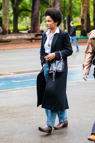 woman wearing tailored top, jeans, and cowboy boots