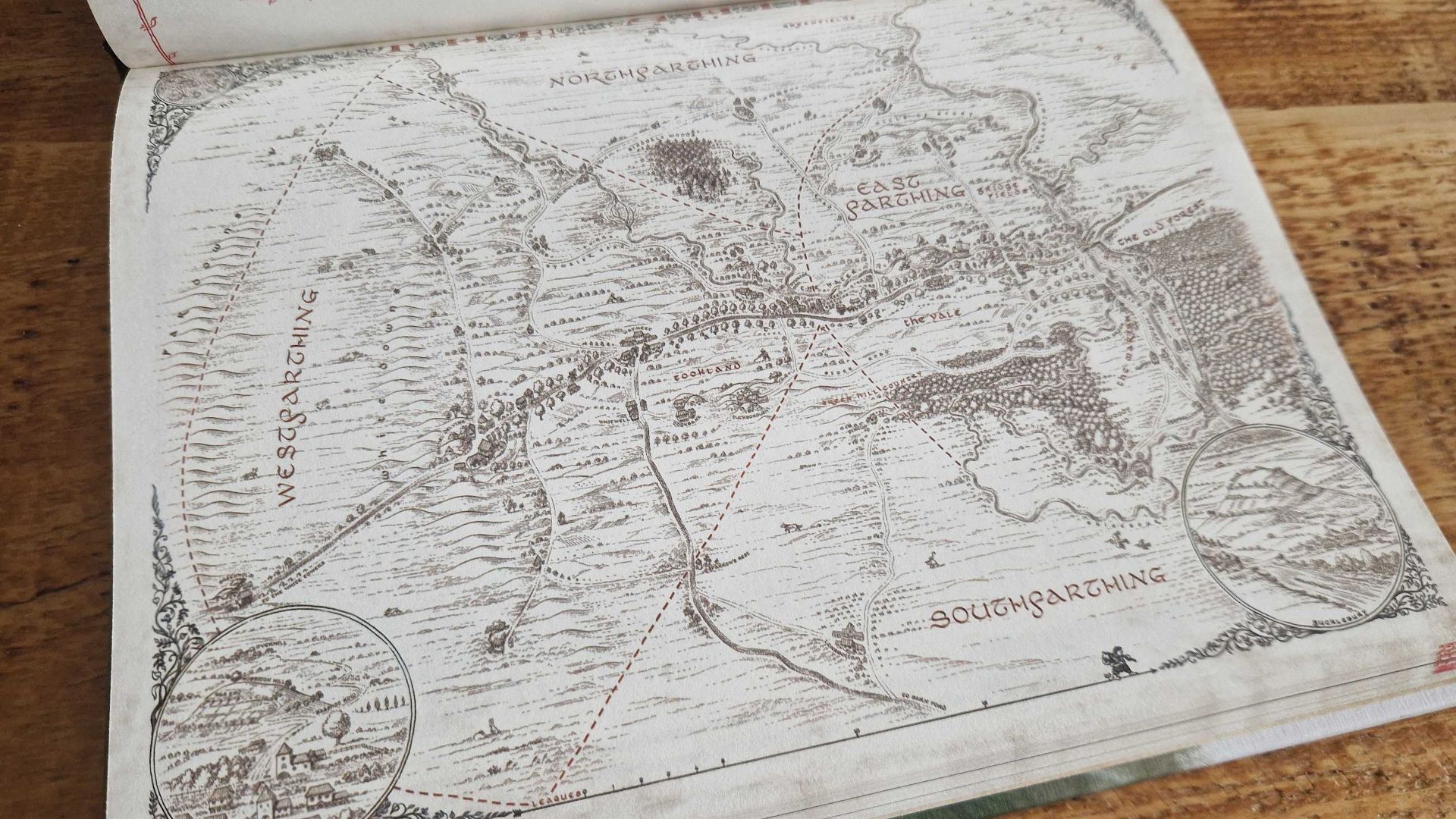 The One Ring Hobbit Tales map of the Shire, laid out on a wooden surface