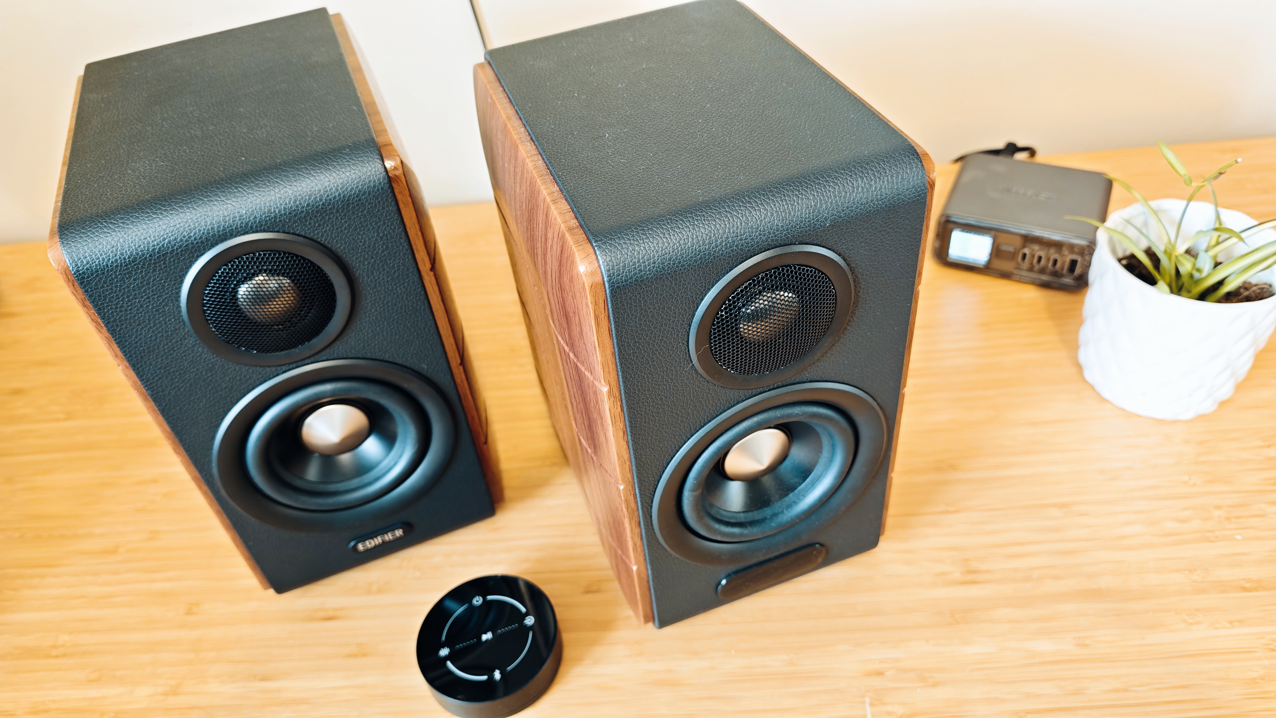Black and brown Edifier S880DB MkII speakers on a wooden desk