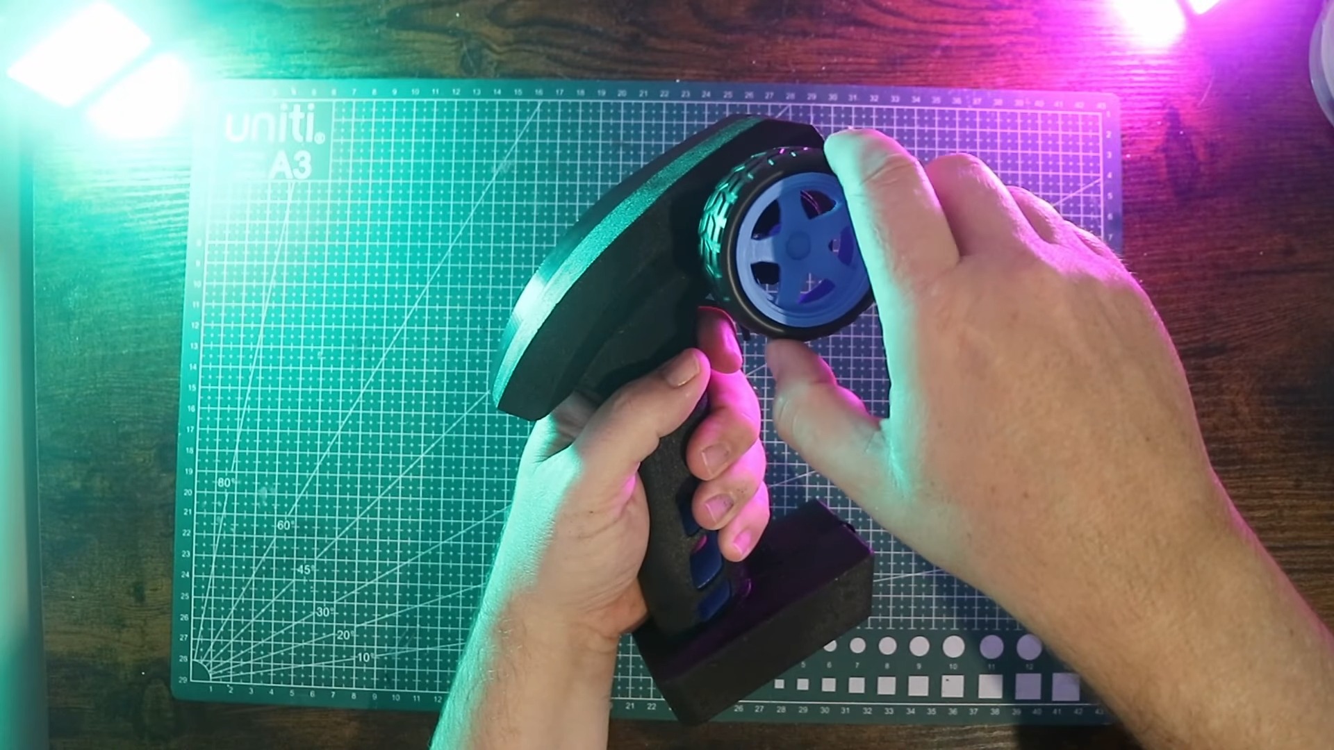 A screenshot from a YouTube video by Jason Winfield showing him holding the pistol grip force feedback controller