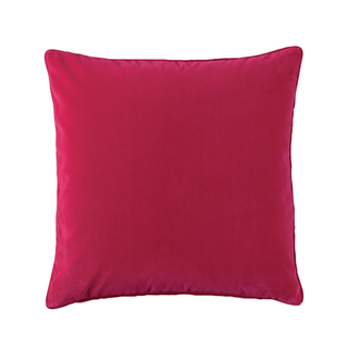 A velvet magenta throw cushion