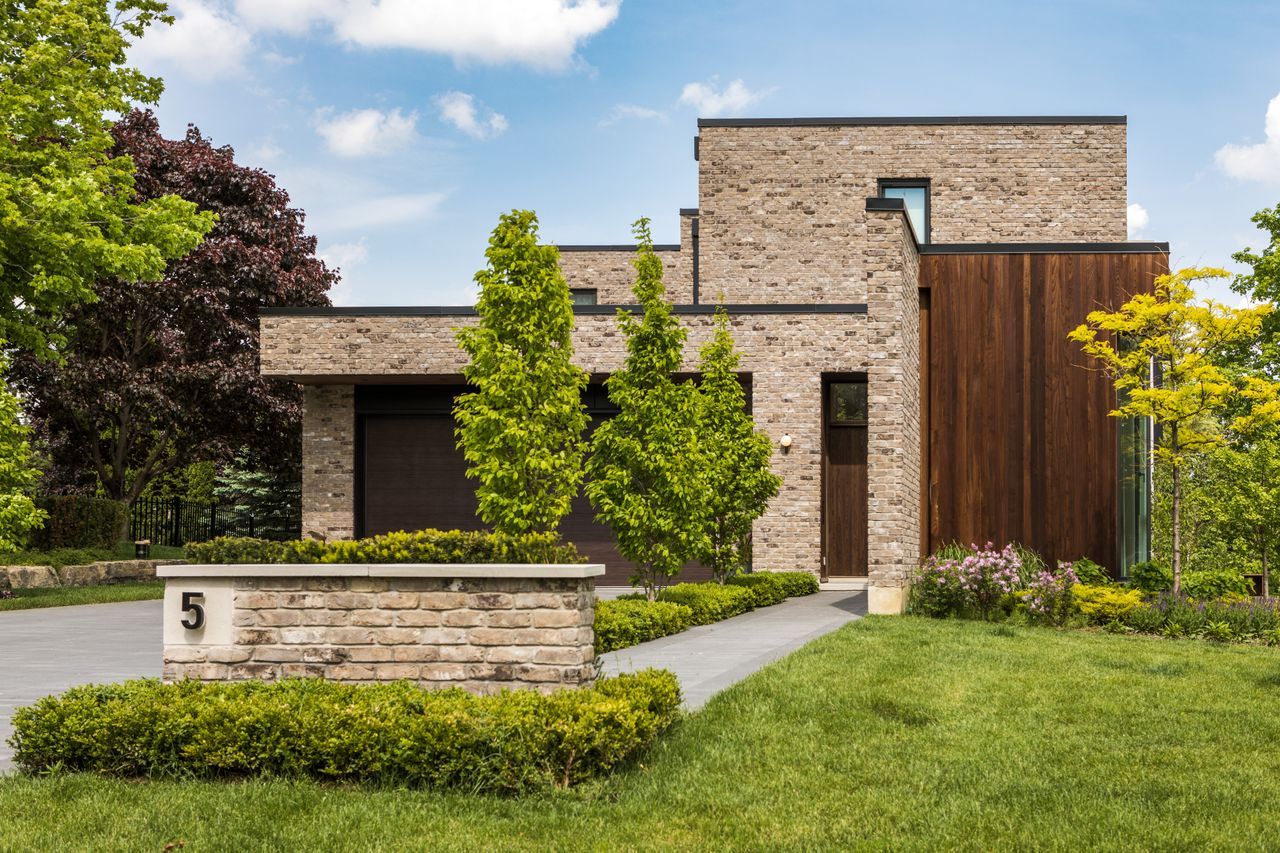 Brick home with lawn and planting