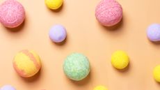selection of colored bath bombs on orange background
