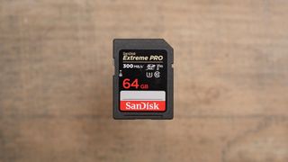 The SanDisk Extreme PRO SDXC UHS-II SD card on a wooden table