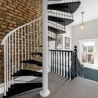 Black spiral staircase with white railing