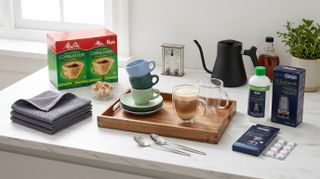 Collection of coffee-making accessories spread out on a marble countertop