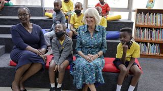 Camilla, Duchess of Cornwall smiles with young students as she attends a BookAid/Q.C.E.C event with Jeannette Kagame