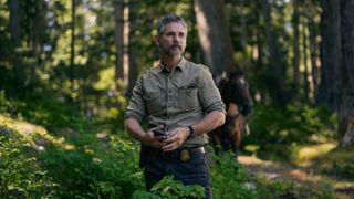 Kyle Turner (Eric Bana) stands in the forest in a scene from Netflix's "Untamed"