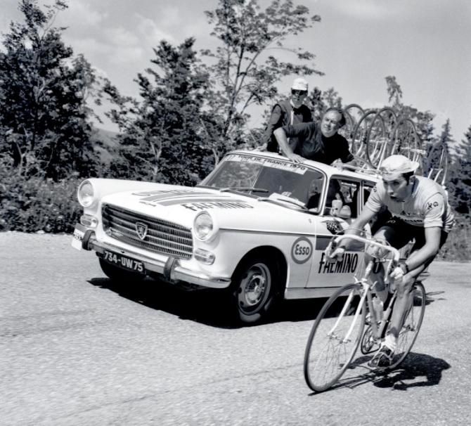 Belgian Eddy Merckx, wearing the yellow jersey of leader, rides as his manager Guillaume Driessens looks on during the 10th stage of the Tour de France between Belfort and Divonne-les-Bains 06 July 1970. Merckx won the stage and went on to win his second consecutive Tour de France.