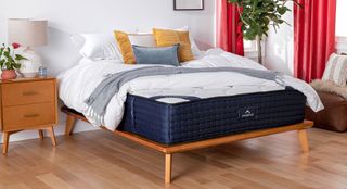 DreamCloud Luxury Hybrid mattress on a bed in a bedroom