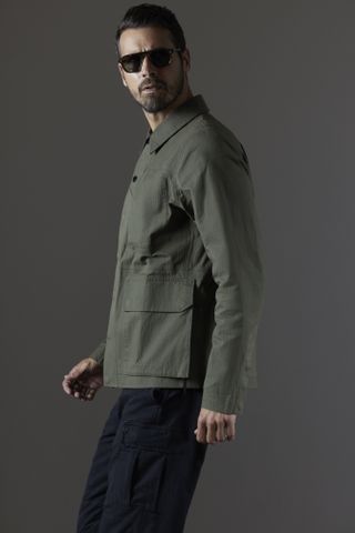 A man wearing a green jacket