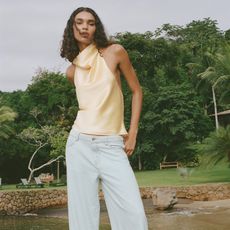 model wears butter yellow shirt and loose jeans