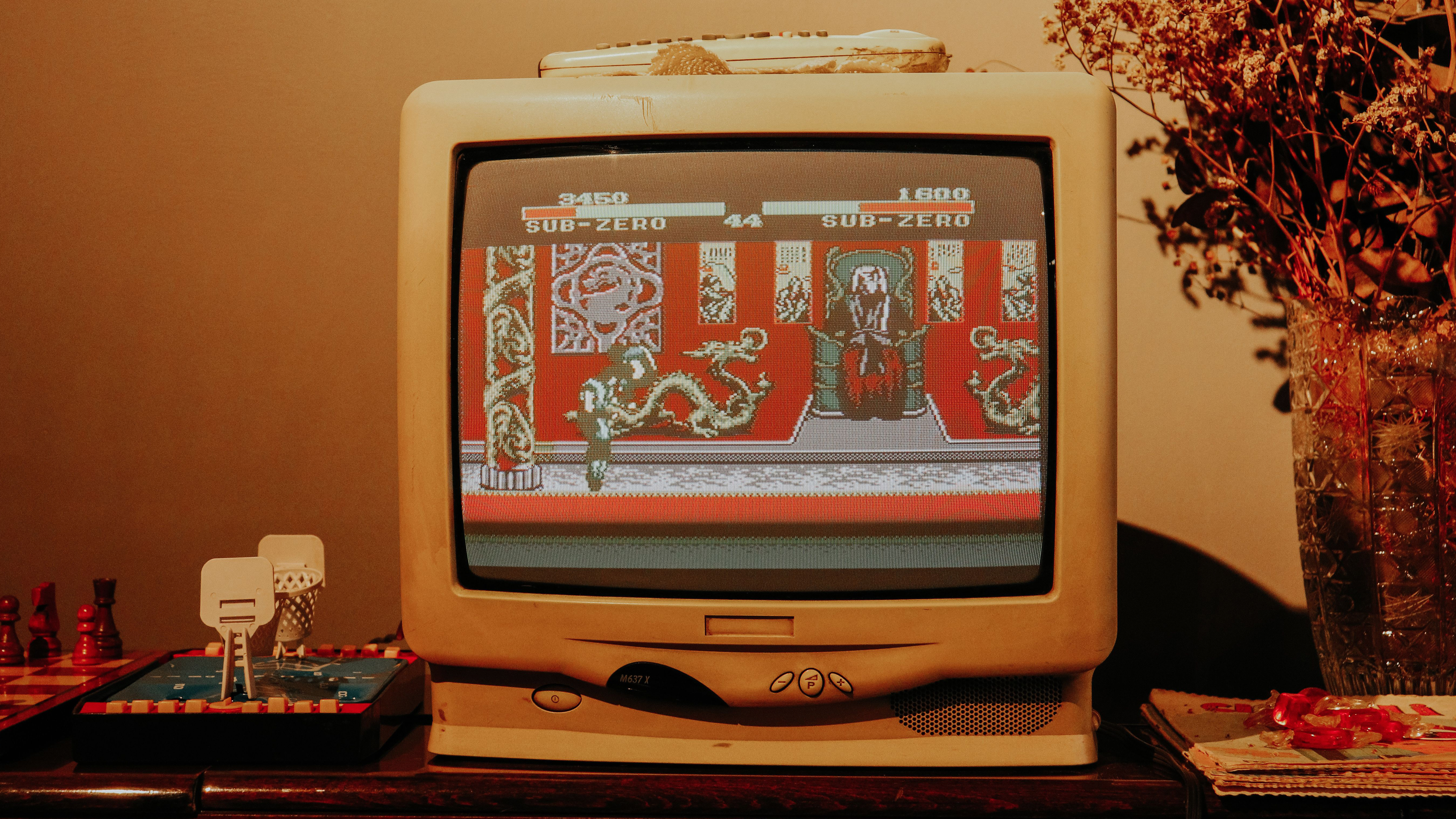 An old CRT TV has Mortal Kombat on the screen
