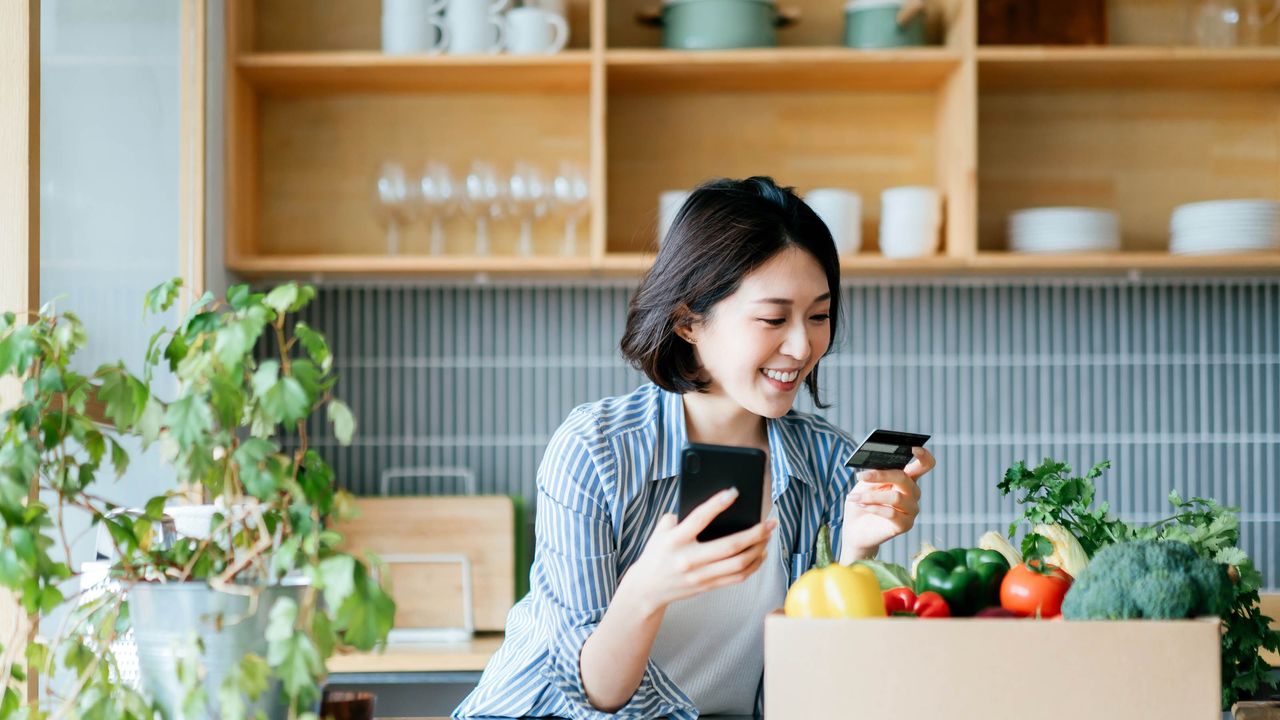 Woman paying for organic groceries with a credit card