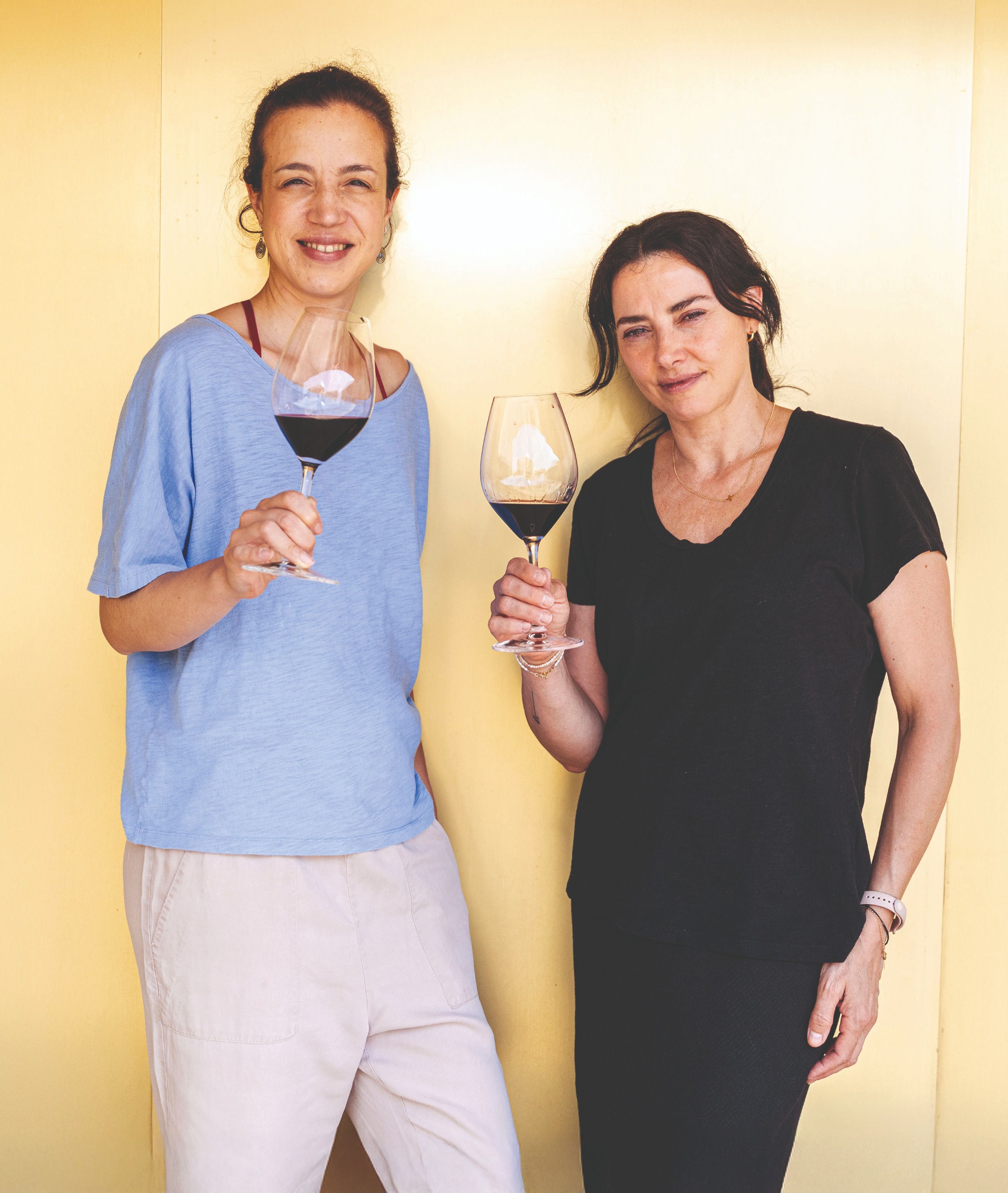 Ines and Maria holding glasses of wine