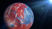 Image of a planet in space. The planet has red land masses surrounded by large areas of blue water dotted with white clouds.