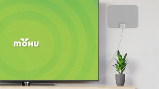 The Mohu Leaf in a living room near a TV.