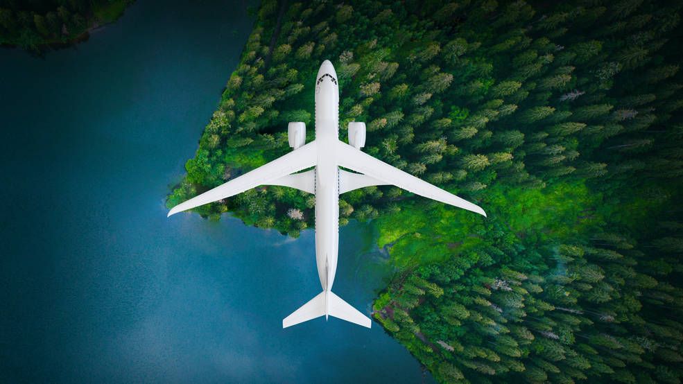 graphic illustration showing an aerial view of the X-66A plane flying above water and a forested area to the right.