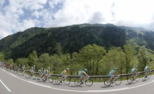 The riders go around a mountain curve