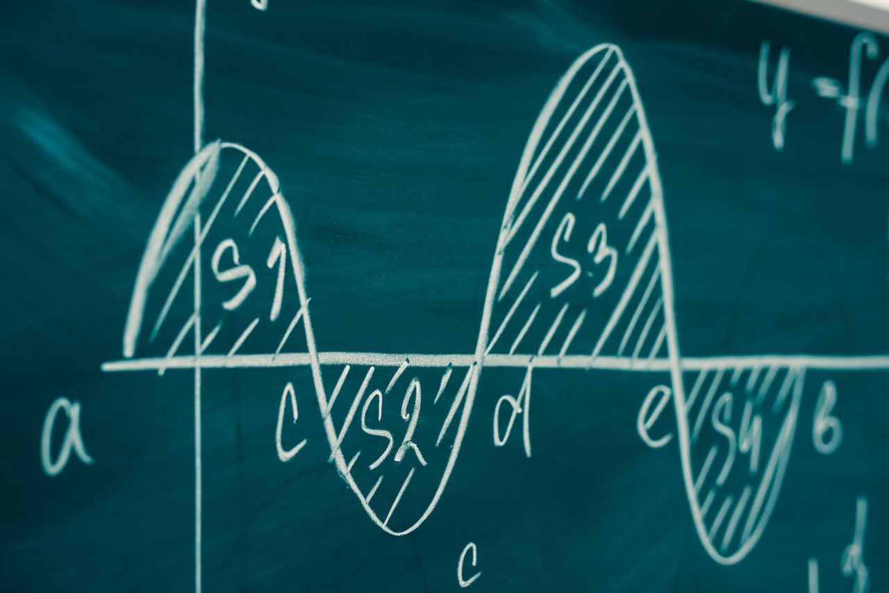 a drawing on a chalkboard showing area under a curve