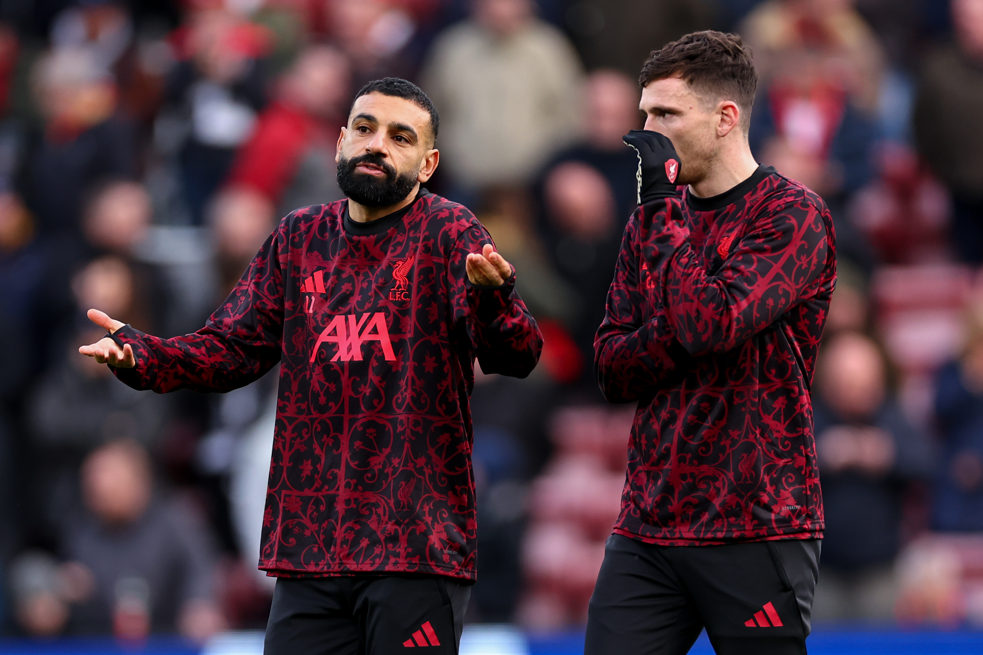 LIVERPOOL, ENGLAND - DECEMBER 13: Mohamed Salah of Liverpool speaks with Andrew Robertson of Liverpool during the Premier League match between Liverpool and Brighton &amp;amp; Hove Albion at Anfield on December 13, 2025 in Liverpool, England. (Photo by Robbie Jay Barratt - AMA/Getty Images)