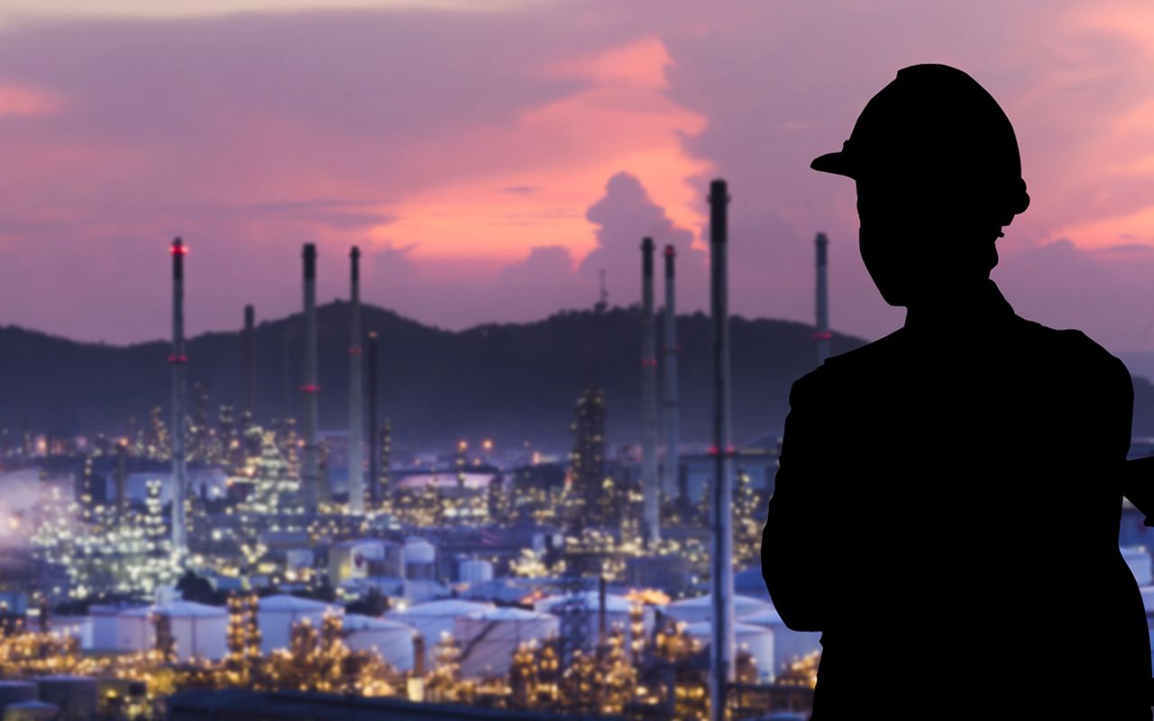 Silhouette engineers are standing orders The oil refining industry