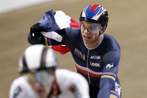 Frenchman Kevin Sireau celebrates with French flag after winning the gold medal during the team sprint