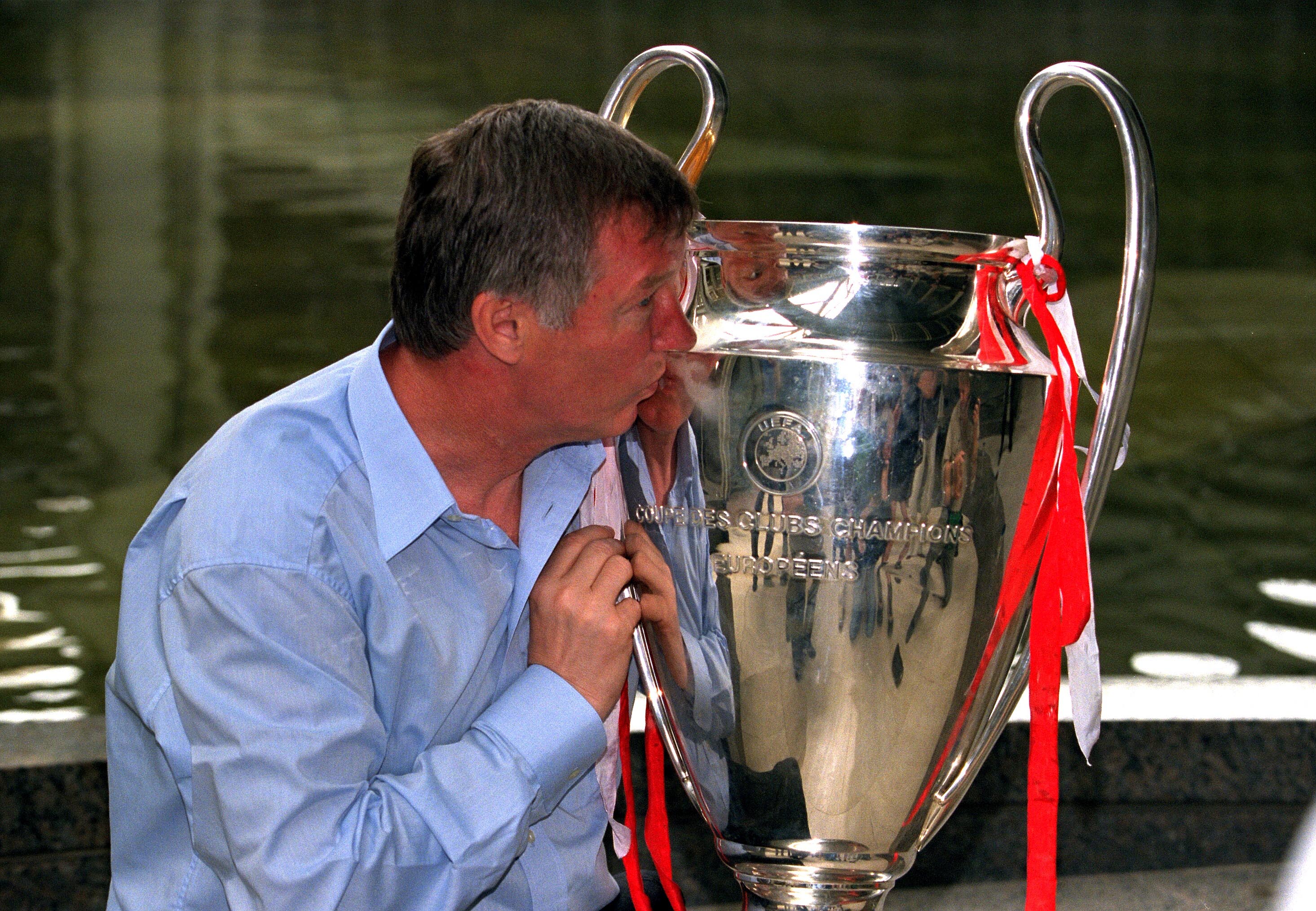 Alex Ferguson kisses the Champions League trophy the morning after Manchester United's win over Bayern Munich in the 1999 final.