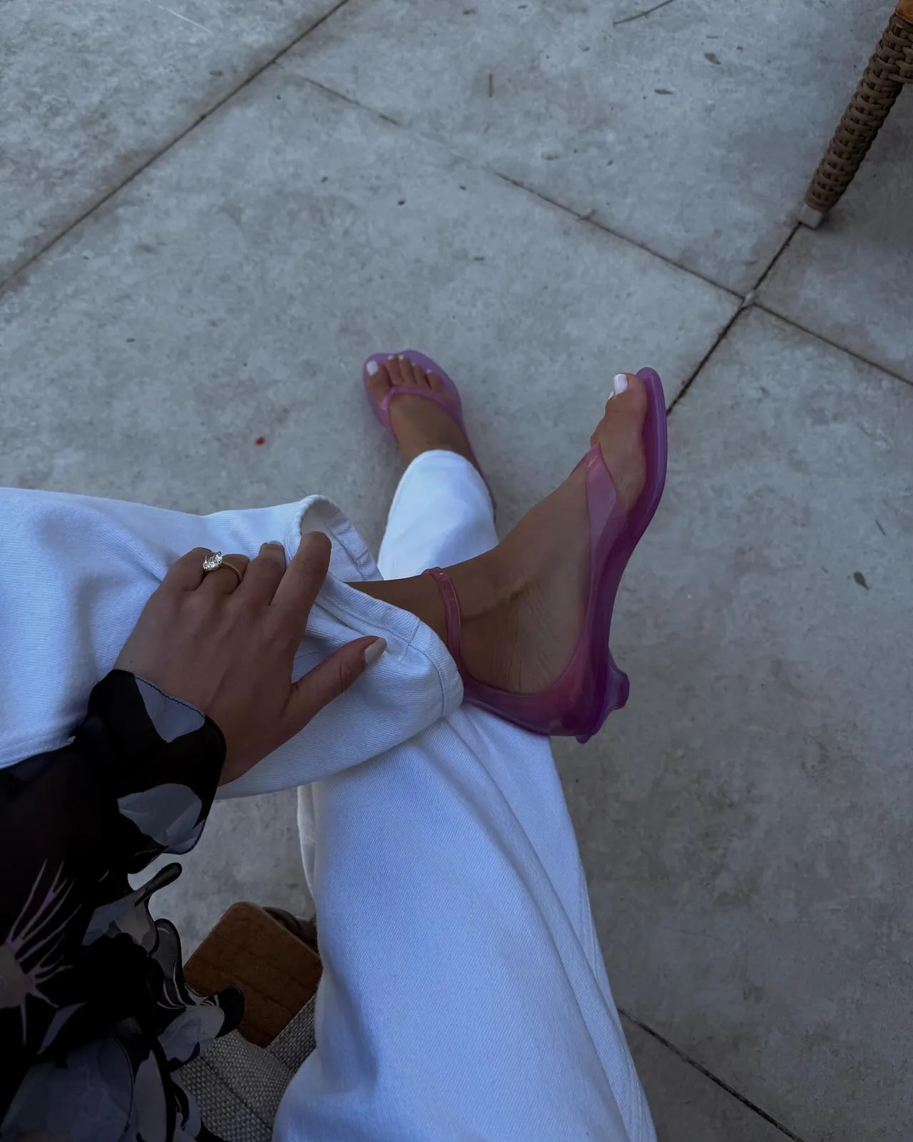 An image of @ariellecharnas wearing the Chloe TPU Jelly Sandals, one of the 'It' sandals of 2025.