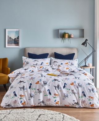 floral bedroom with blue walls and box frame shelf