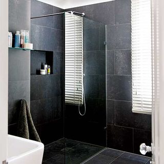 bathroom with tiles floor and shower