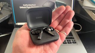 Listing image for best fake Airpods showing OnePlus Buds Pro 2 in charging case held in hand