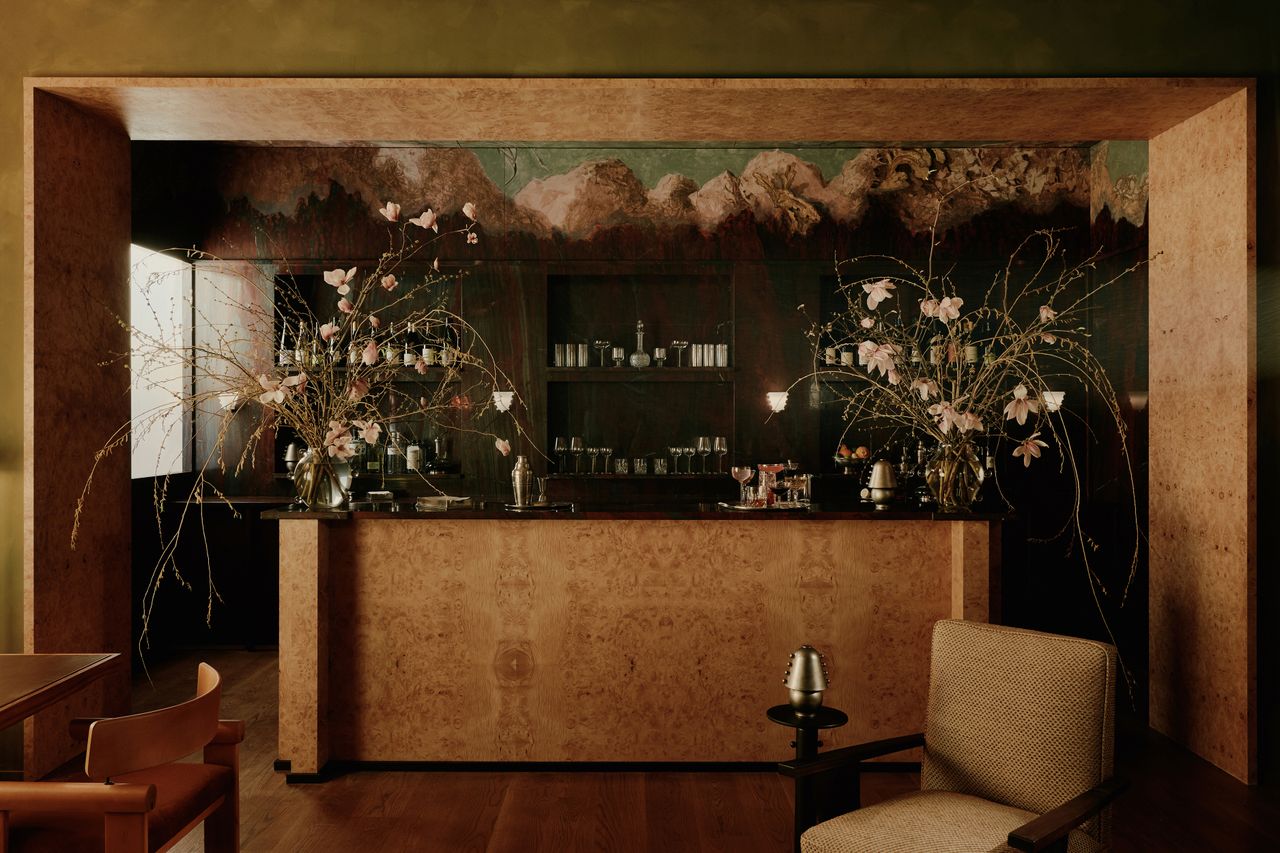 a retro 70s-inspred bar made from burl with eclectic cocktail glasses