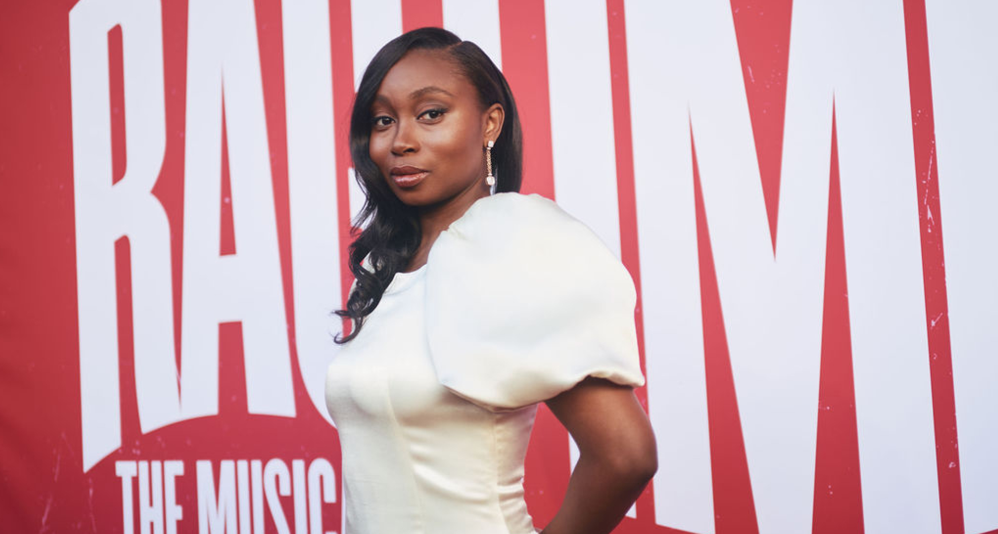 ragtime actress nichelle lewis wears a white dress while posing on the opening night red carpet for the broadway show