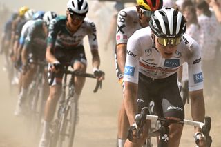 Tadej Pogacar riding over a cobblestone sector at the 2022 Tour de France