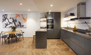 An open plan kitchen with herringbone floor