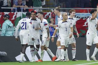 USA players celebrate a goal against Wales at the 2022 World Cup.