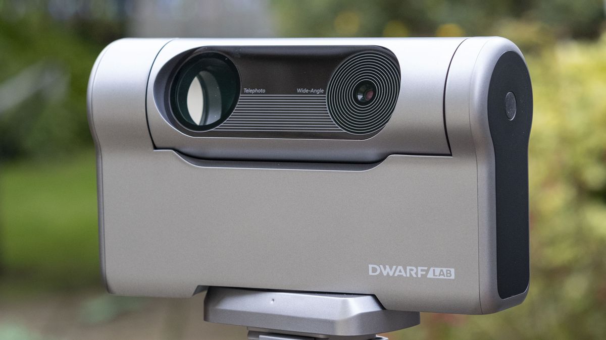 The Dwarf III smart telescope photographed in a garden, showing the front of the device