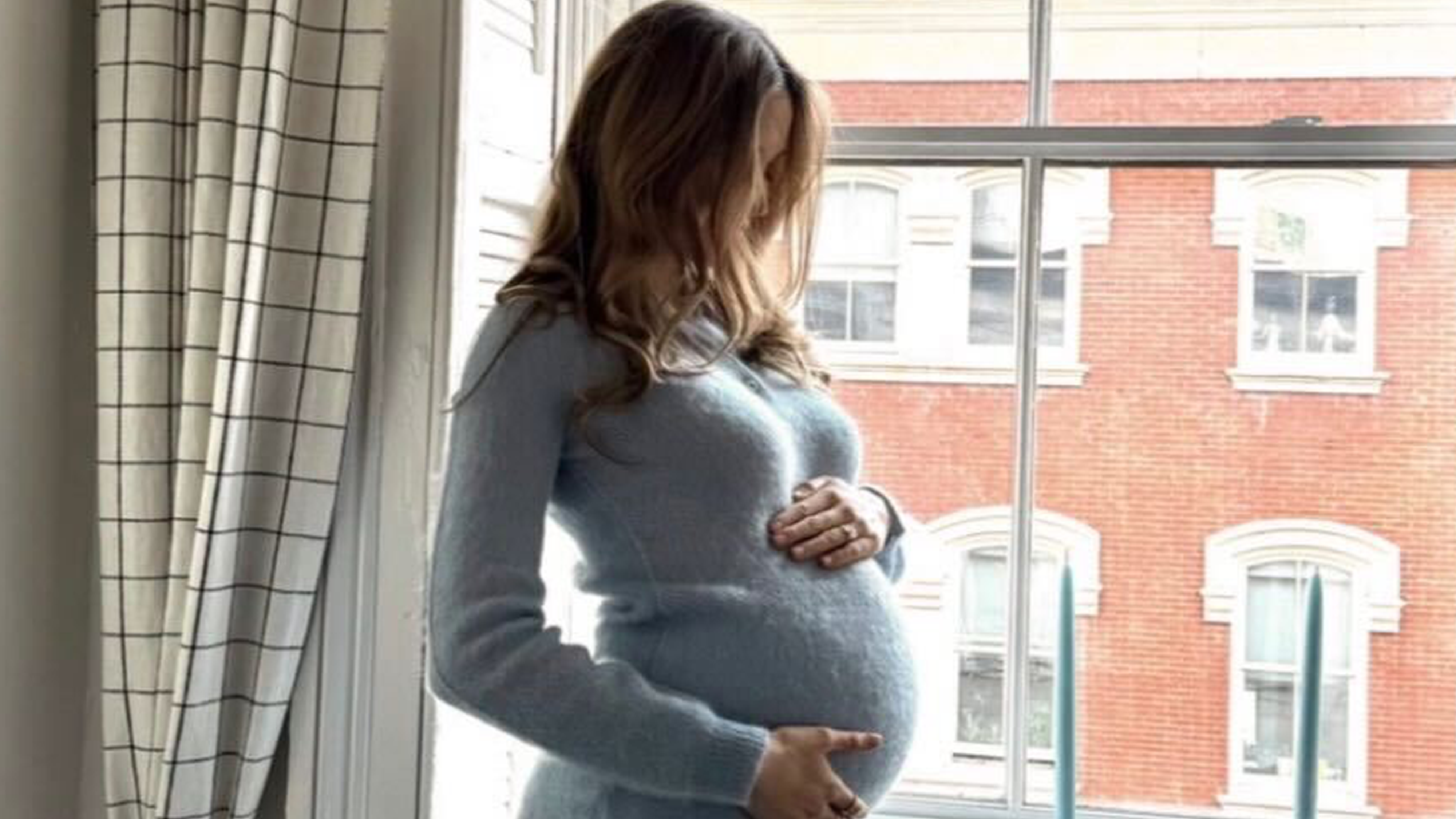 Photo of Elizabeth Grace Hand wearing her maternity dress for baby shower party.